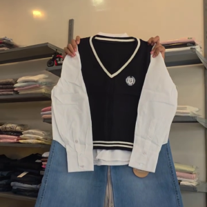 Women’s Trendy Navy Sleeveless V-Neck Sweater Vest Layered Over White Button-Down Shirt with Light Blue Wide-Leg Denim Jeans for Stylish Preppy Casual Co-Ord Fashion