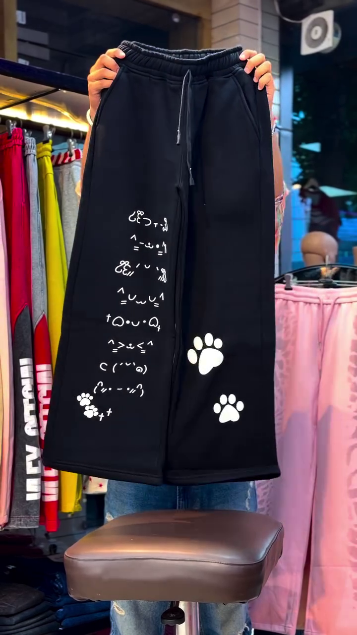 Women’s Trendy Black Casual Co-Ord Set with White Sleeveless Cropped Vest Jacket, Printed Cat & Paw Graphic Wide-Leg Trousers, Adjustable Drawstring Waist and Playful Streetwear Styling